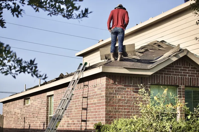Professional roofer working on a residential roof in Cunningham Acres